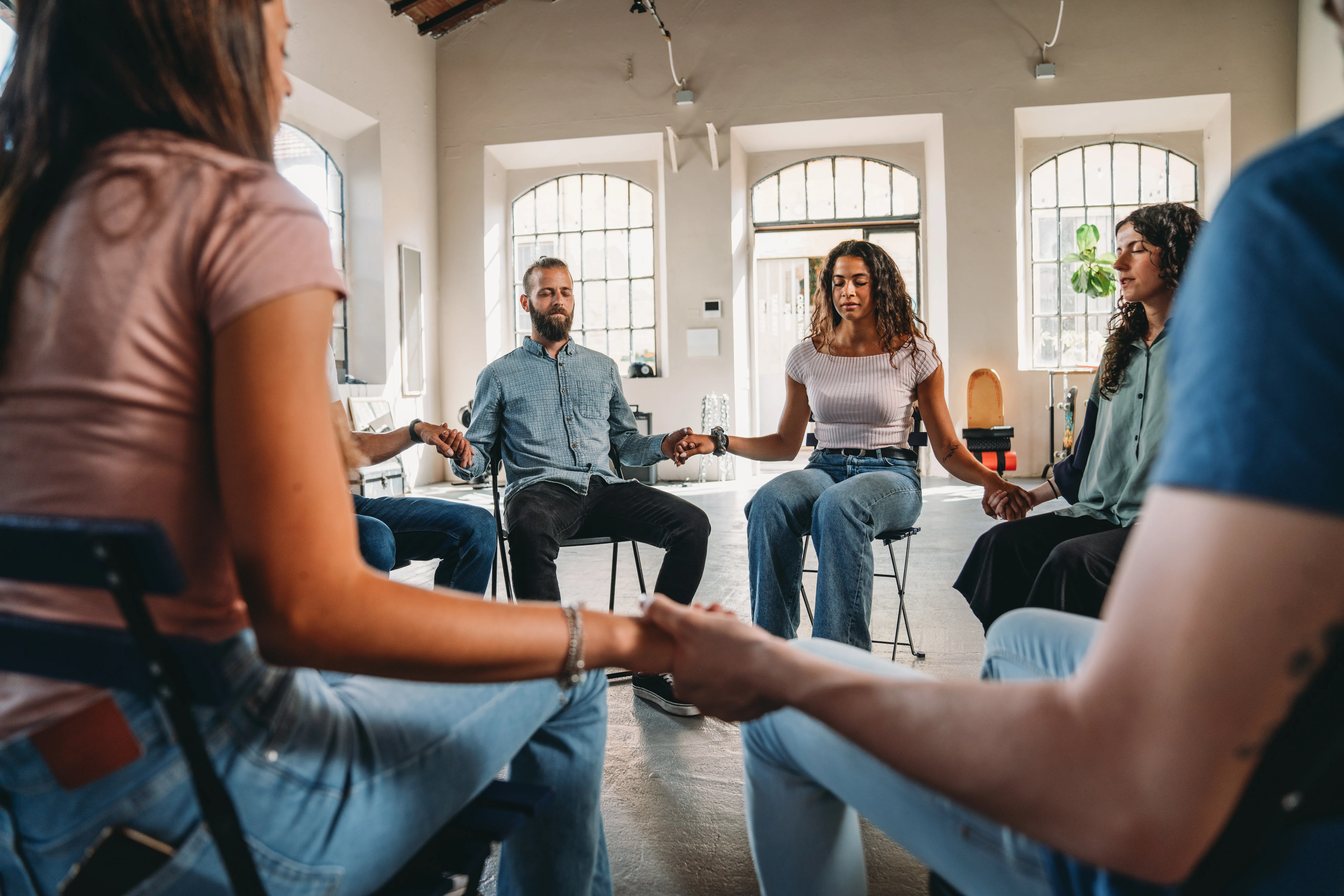 A group holding hands and praying together